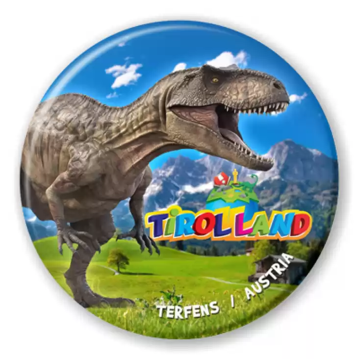 przypinka Tirolland Tyranozaur na tle gór