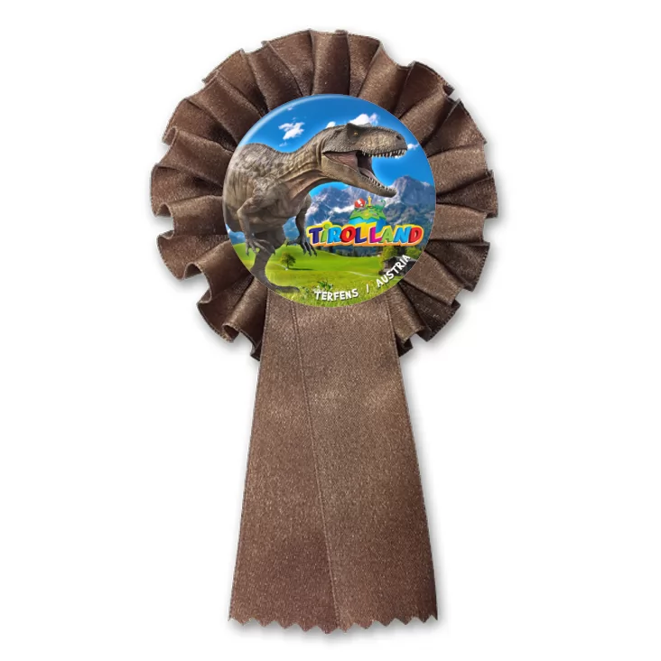 przypinka kotylion Tirolland Tyranozaur na tle gór