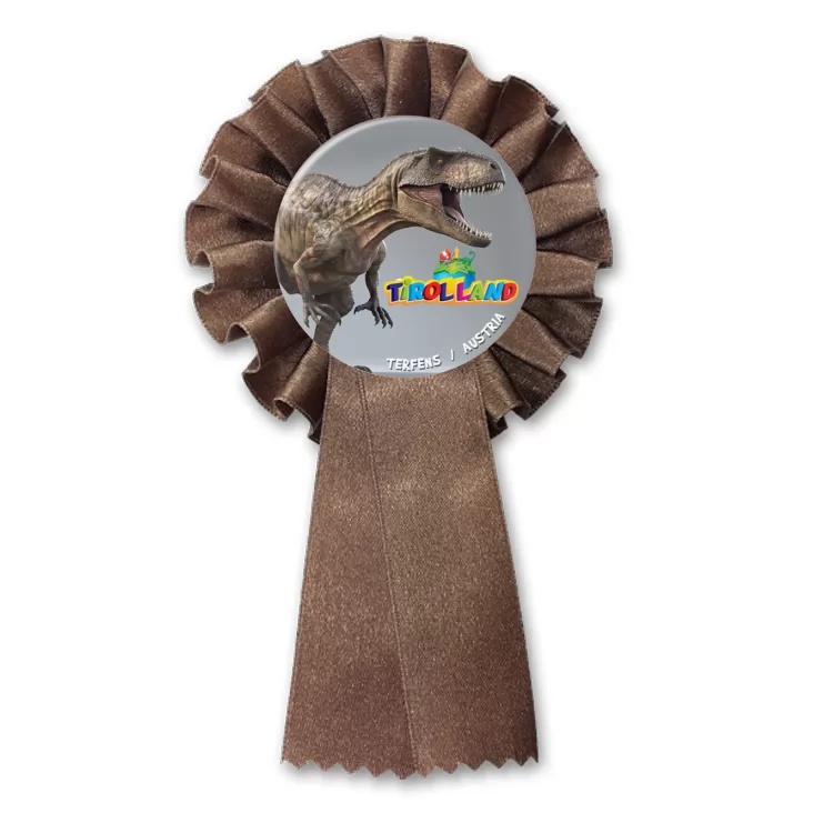 przypinka kotylion Tirolland Tyranozaur na szarym tle