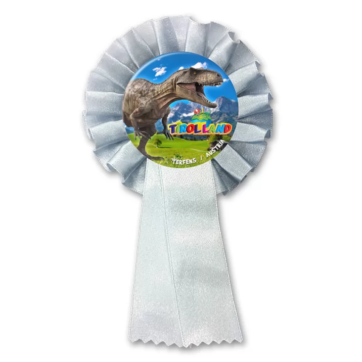 przypinka kotylion Tirolland Tyranozaur na tle gór