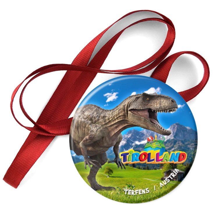 przypinka medal Tirolland Tyranozaur na tle gór