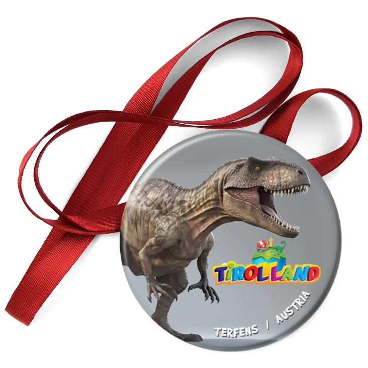 przypinka medal Tirolland Tyranozaur na szarym tle