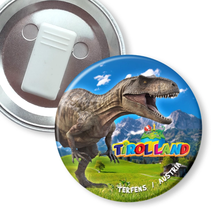 przypinka z żabką Tirolland Tyranozaur na tle gór